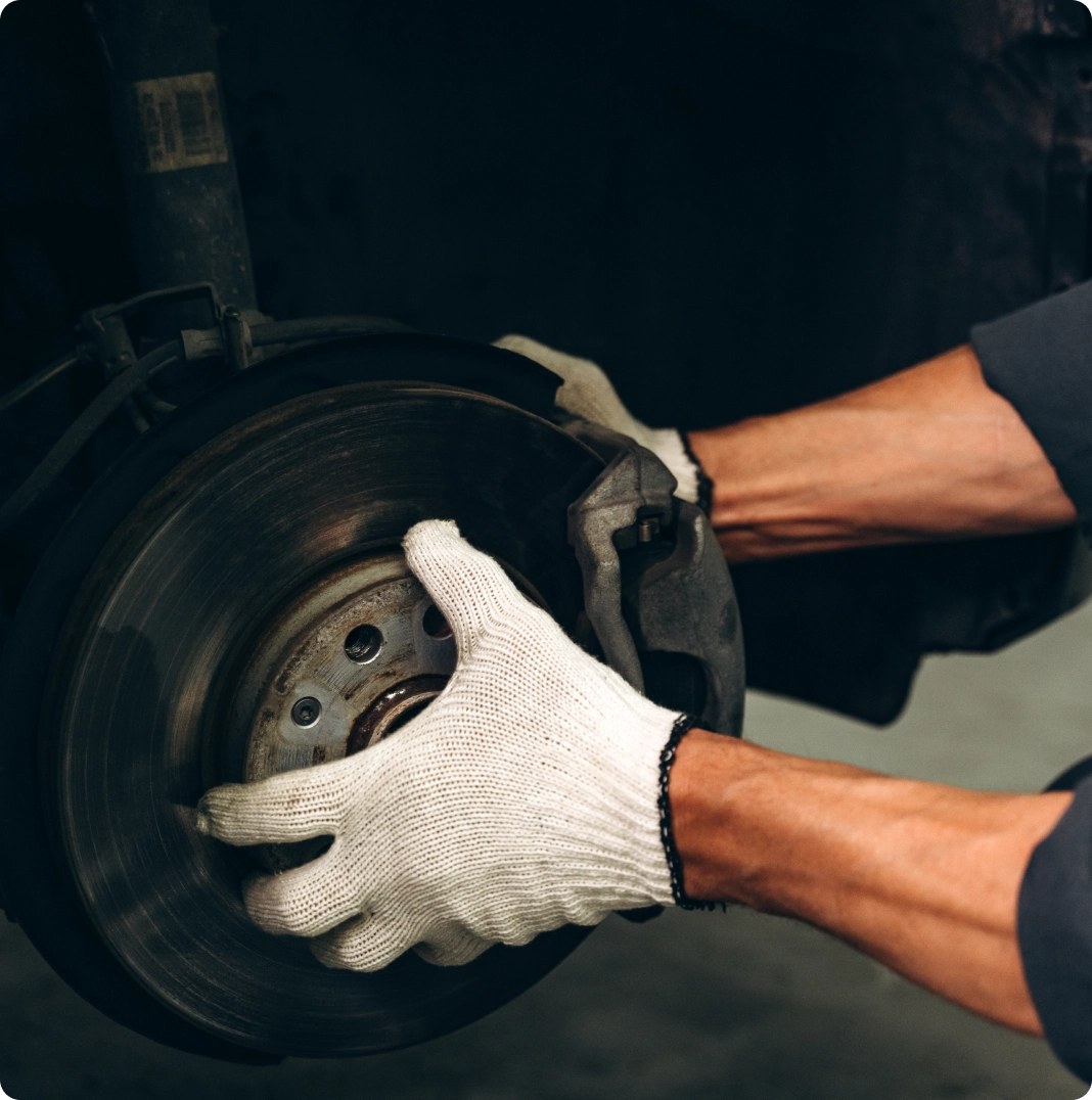 Technician checking brake callipers