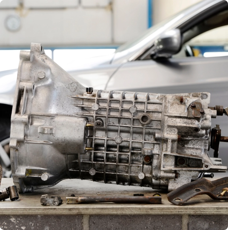 Vehicle transmission assembly on a workbench in an auto repair shop