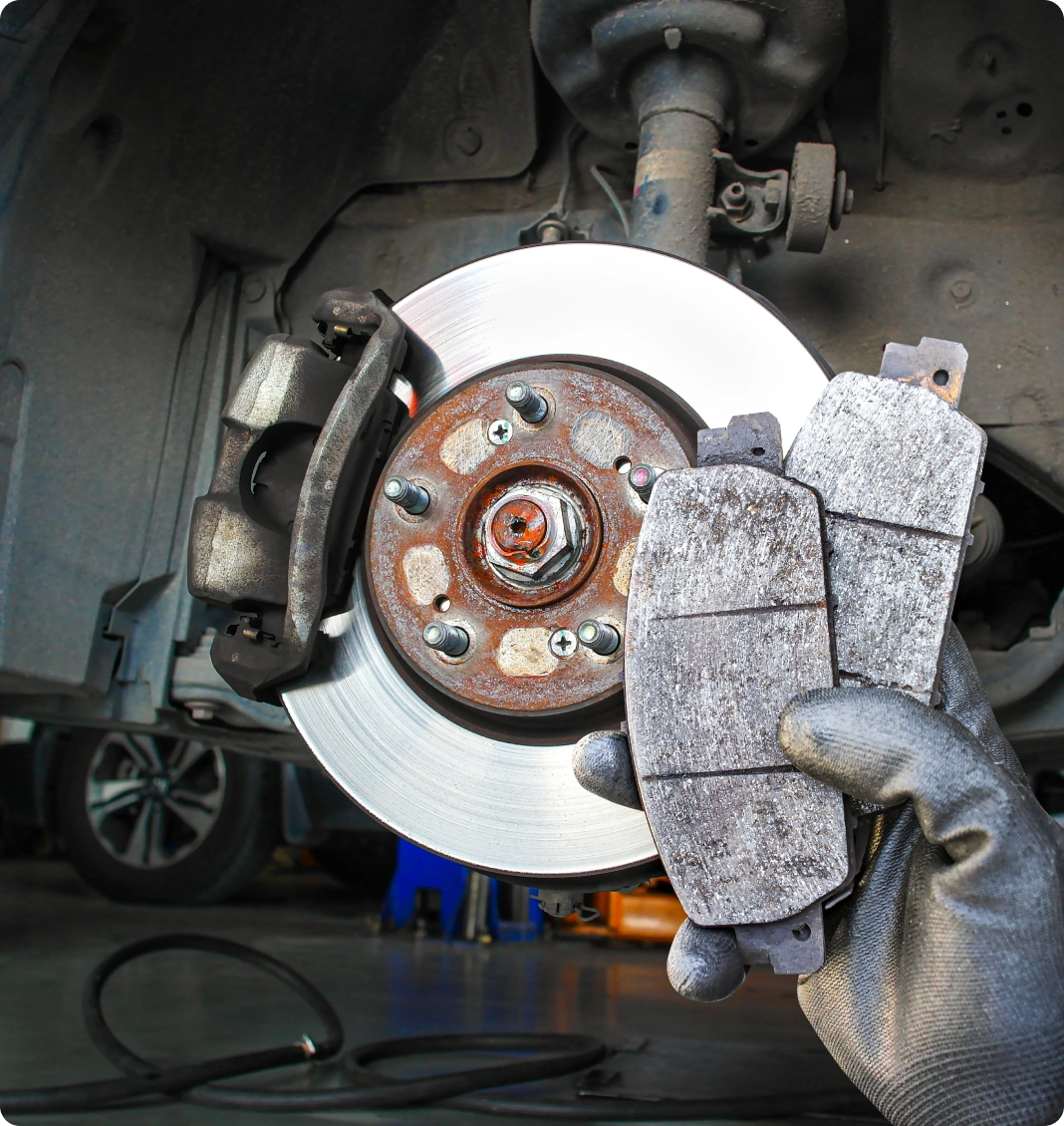 Technician holiding brake pads