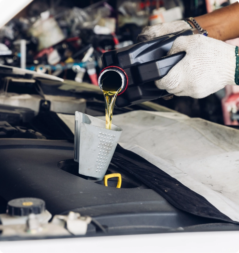 Technician measuring oil during an oil change