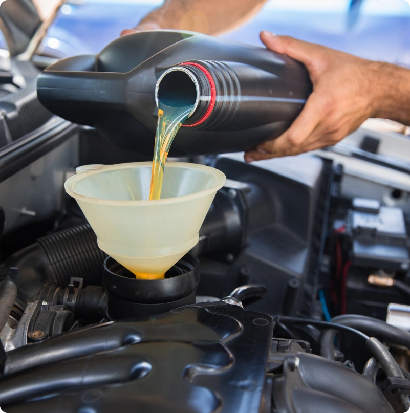 Fresh engine oil being poured through a funnel